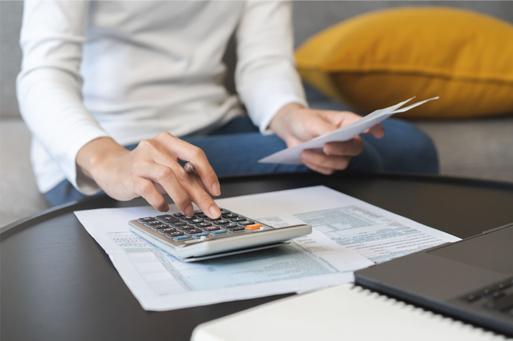 Woman calculating the tax benefits of buying a commercial property